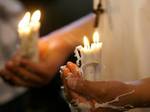 Pilgrims walk in processions to the shrines carrying lighted candles and bearing floral offerings