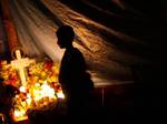 Mexicans pay homage to their dead relatives by preparing meals and decorating their graves