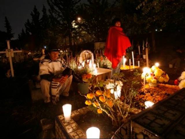 Mexicans pay homage to their dead relatives by preparing meals and decorating their graves