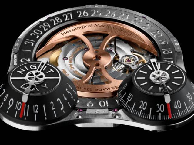 The twin cones respectively indicate hours and minutes, with the hour cone capped by a day/night indicator