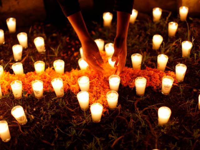 Mexicans pay homage to their dead relatives by preparing meals and decorating their graves
