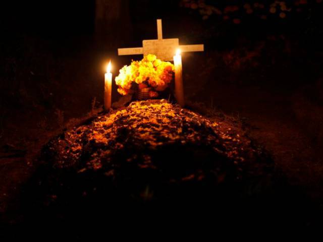 Mexicans pay homage to their dead relatives by preparing meals and decorating their graves